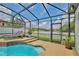 Relaxing screened-in pool area featuring lounge chairs and a dining set, perfect for outdoor enjoyment at 3180 Pawleys N Loop, St Cloud, FL 34769