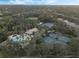 Community amenities featuring a pool, clubhouse, and tennis courts surrounded by lush landscaping and mature trees at 3214 Regal Crest Dr, Longwood, FL 32779