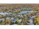 Scenic aerial perspective showcasing a community with shimmering lakes and beautifully landscaped properties at 3214 Regal Crest Dr, Longwood, FL 32779