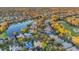 Picturesque aerial view of a neighborhood featuring a tranquil lake and lush green golf course at 3214 Regal Crest Dr, Longwood, FL 32779