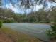 Outdoor basketball court with multiple hoops, surrounded by mature trees and green spaces at 3214 Regal Crest Dr, Longwood, FL 32779