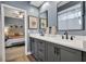 Bathroom with double vanity, gray cabinetry, and a view of the adjacent bedroom at 3214 Regal Crest Dr, Longwood, FL 32779