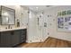 Stylish bathroom showcases a glass shower, dark vanity, and modern fixtures at 3214 Regal Crest Dr, Longwood, FL 32779