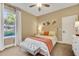 Inviting bedroom with a large window, soft lighting, and a cozy atmosphere at 3214 Regal Crest Dr, Longwood, FL 32779