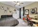 Cozy bedroom features neutral walls, a ceiling fan, and a dedicated desk space at 3214 Regal Crest Dr, Longwood, FL 32779