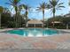 Relaxing community pool area with tall palm trees, comfortable lounge chairs, and crystal-clear water at 3214 Regal Crest Dr, Longwood, FL 32779