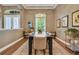 Bright dining room features a dark wood table and a large window with plantation shutters at 3214 Regal Crest Dr, Longwood, FL 32779