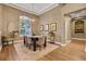 Inviting dining room features a stylish chandelier and a large window providing ample natural light at 3214 Regal Crest Dr, Longwood, FL 32779
