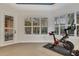 Well-lit exercise room with a stationary bike and views from the beautiful windows at 3214 Regal Crest Dr, Longwood, FL 32779