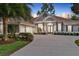 Beautiful exterior of a home with a three-car garage, well-kept landscaping, and a circular driveway at 3214 Regal Crest Dr, Longwood, FL 32779