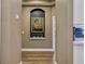 Hallway view of an alcove with art and wood floors seamlessly connecting to the living spaces at 3214 Regal Crest Dr, Longwood, FL 32779