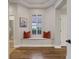 Inviting hallway nook featuring a window seat with orange pillows and wood flooring at 3214 Regal Crest Dr, Longwood, FL 32779