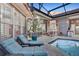 Covered lanai featuring lounge chairs, an outdoor dining area, and views of the pool at 3214 Regal Crest Dr, Longwood, FL 32779