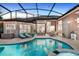 Relaxing lanai with a swimming pool, outdoor kitchen, dining, and lounging areas at 3214 Regal Crest Dr, Longwood, FL 32779