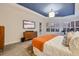 Bright and airy main bedroom features a king bed and a window with shutters at 3214 Regal Crest Dr, Longwood, FL 32779