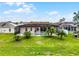 An aerial view showcases the home's backyard oasis with pool, screened enclosure, and lush landscaping at 335 Prestwick Dr, Davenport, FL 33897