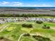 Overhead shot of homes with an adjacent golf course in a neighborhood at 335 Prestwick Dr, Davenport, FL 33897