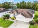 Beautiful single-story home with manicured lawn, landscaping, two-car garage, and screened-in pool area at 335 Prestwick Dr, Davenport, FL 33897