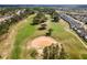 Picturesque aerial view of golf course with mature trees, sand traps, and lush fairways at 335 Prestwick Dr, Davenport, FL 33897
