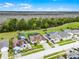 Aerial view of homes, manicured lawns, and beautiful conservation area in the background at 335 Prestwick Dr, Davenport, FL 33897