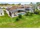 An aerial view highlights the backyard pool, screened-in lanai, and lush green lawn at 335 Prestwick Dr, Davenport, FL 33897