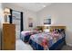 Cozy bedroom with two twin beds featuring themed bedspreads, window and ceiling fan at 335 Prestwick Dr, Davenport, FL 33897