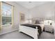 Cozy bedroom featuring a bed, a nightstand with lamp, and a window at 335 Prestwick Dr, Davenport, FL 33897
