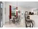 Dining area with a chandelier above a glass top table and a sliding glass door at 335 Prestwick Dr, Davenport, FL 33897