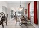 Dining area next to sliding glass door with a chandelier above a glass top table at 335 Prestwick Dr, Davenport, FL 33897