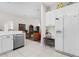 Kitchen area with white cabinets and stainless steel appliances that opens into the living area at 335 Prestwick Dr, Davenport, FL 33897