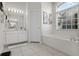 Bright main bathroom features a soaking tub and dual sink vanity with ample lighting at 335 Prestwick Dr, Davenport, FL 33897