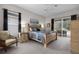 Comfortable main bedroom features a ceiling fan, neutral carpet and access to the screened lanai at 335 Prestwick Dr, Davenport, FL 33897
