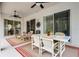 Covered patio with outdoor dining area and lounge chairs with pool view at 335 Prestwick Dr, Davenport, FL 33897