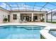 A spacious outdoor pool features a spa and covered patio with plenty of room for seating and entertaining at 335 Prestwick Dr, Davenport, FL 33897