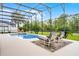Relax by the screened pool and enjoy the Florida sunshine from comfortable lounge chairs at 335 Prestwick Dr, Davenport, FL 33897