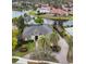 Aerial view of waterfront estate showcasing lush landscaping, paver driveway, and serene lake views at 3358 Fernlake Pl, Longwood, FL 32779