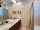 Charming bathroom features a double sink vanity with marble countertop and a shower-tub combo at 3358 Fernlake Pl, Longwood, FL 32779