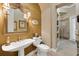 Half-bathroom with pedestal sink, decorative mirror, and a view into the tiled walk-in shower at 3358 Fernlake Pl, Longwood, FL 32779