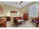 Cozy bedroom features a decorative wood bed frame, plush bedding, and a bright window with shutters at 3358 Fernlake Pl, Longwood, FL 32779