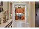 View through doorway to butler pantry featuring custom cabinetry, granite countertops, and wine fridge at 3358 Fernlake Pl, Longwood, FL 32779