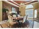 Formal dining room featuring decorative rug, chandelier, and window with shutters at 3358 Fernlake Pl, Longwood, FL 32779