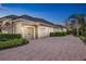 Spacious driveway leading to a three-car garage with well-maintained landscaping and an American flag at 3358 Fernlake Pl, Longwood, FL 32779