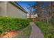 Exterior shot featuring well-maintained landscaping and a brick pathway along the side of the house at 3358 Fernlake Pl, Longwood, FL 32779