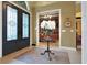 Inviting foyer featuring a decorative floral arrangement, tiled floors, and an open view to other rooms at 3358 Fernlake Pl, Longwood, FL 32779
