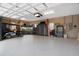 Spacious three-car garage with epoxy flooring, tool cabinets, work benches, and golf cart at 3358 Fernlake Pl, Longwood, FL 32779
