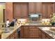 Well-equipped kitchen with granite countertops, stainless steel sink, and decorative backsplash at 3358 Fernlake Pl, Longwood, FL 32779