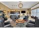 Luxurious living room features a wet bar, a large screen tv, and elegant furniture at 3358 Fernlake Pl, Longwood, FL 32779