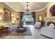 Bright living room with neutral tones, large windows, and a cozy seating arrangement with fireplace at 3358 Fernlake Pl, Longwood, FL 32779