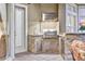 Well-equipped outdoor kitchen with stainless steel appliances, granite countertops, and stone accents at 3358 Fernlake Pl, Longwood, FL 32779