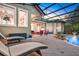 Resort-style pool area with lounge chairs, a covered patio, and lush tropical landscaping at 3358 Fernlake Pl, Longwood, FL 32779